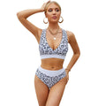 Women's leopard print bikini set with V-neck top and split briefs on a white background.