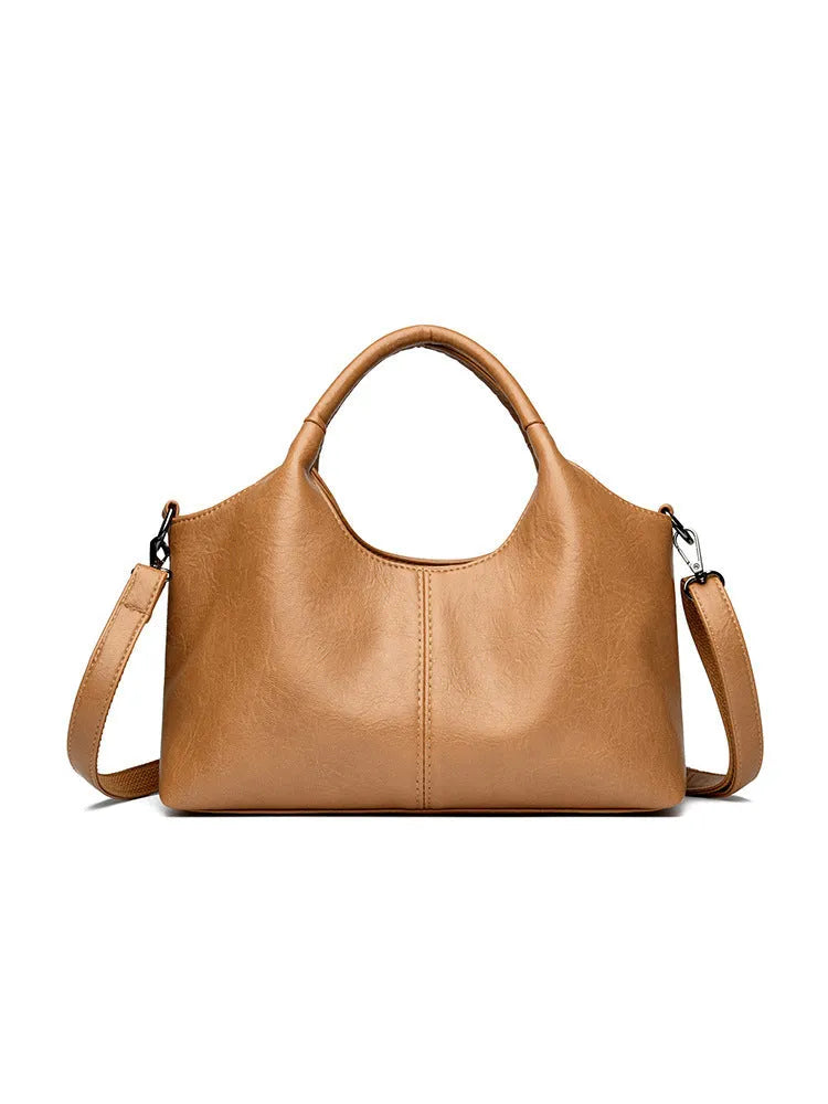 Women's soft genuine leather cross-body bag in beige colour with large capacity.