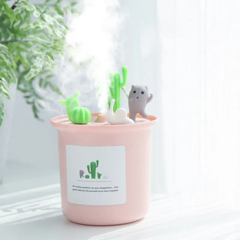 Creative cute pet vase-shaped ultrasonic humidifier in ivory white with USB cable on desk