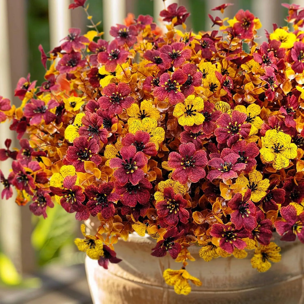 Plastic and silk artificial flower bouquet in autumn red, yellow, orange, and orange-yellow colours for home and event decor.