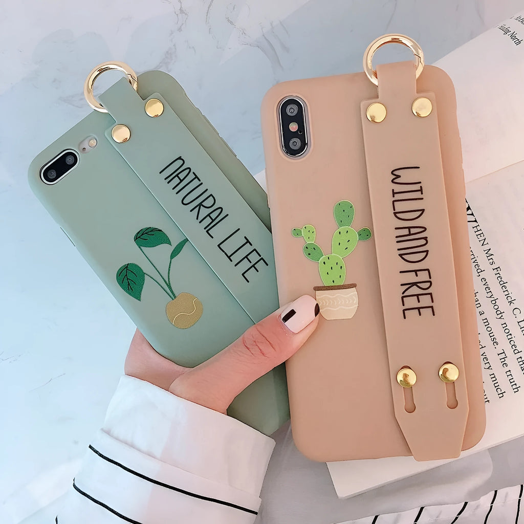 Green iPhone case with a detachable wristband and graffiti print on the back.