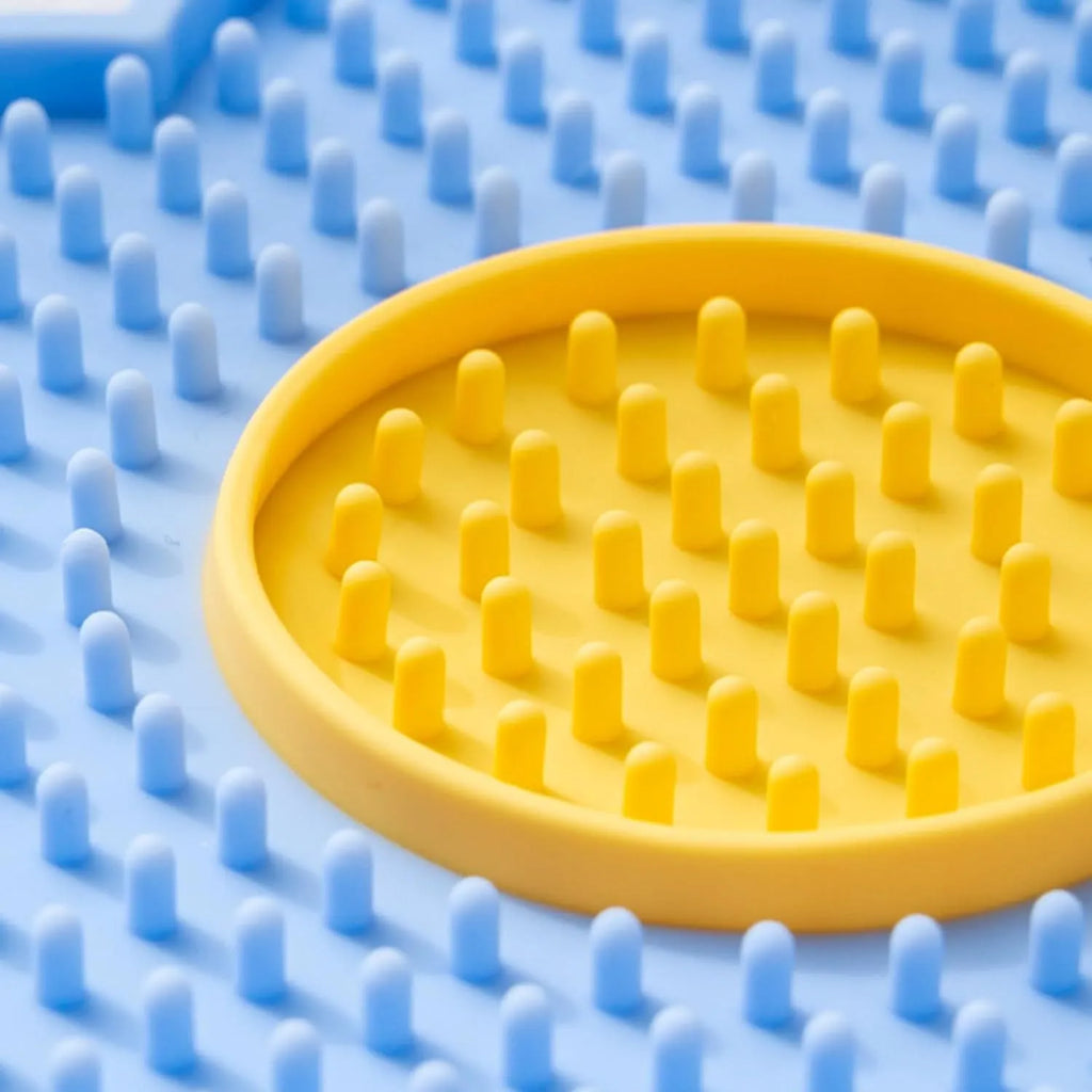 Flower-shaped silicone lick mat for cats and dogs with suction cups on the base, shown in a choice of colours.