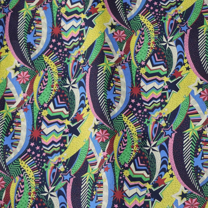 Blue floral printed cotton fabric on a roll showing plant and flower design, 145cm wide.