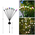 Solar-powered LED garden lamp with multiple light heads and ground plug stakes on a lawn