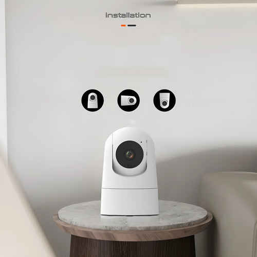 White indoor security camera with pan/tilt mechanism on stand showing front lens and microphone