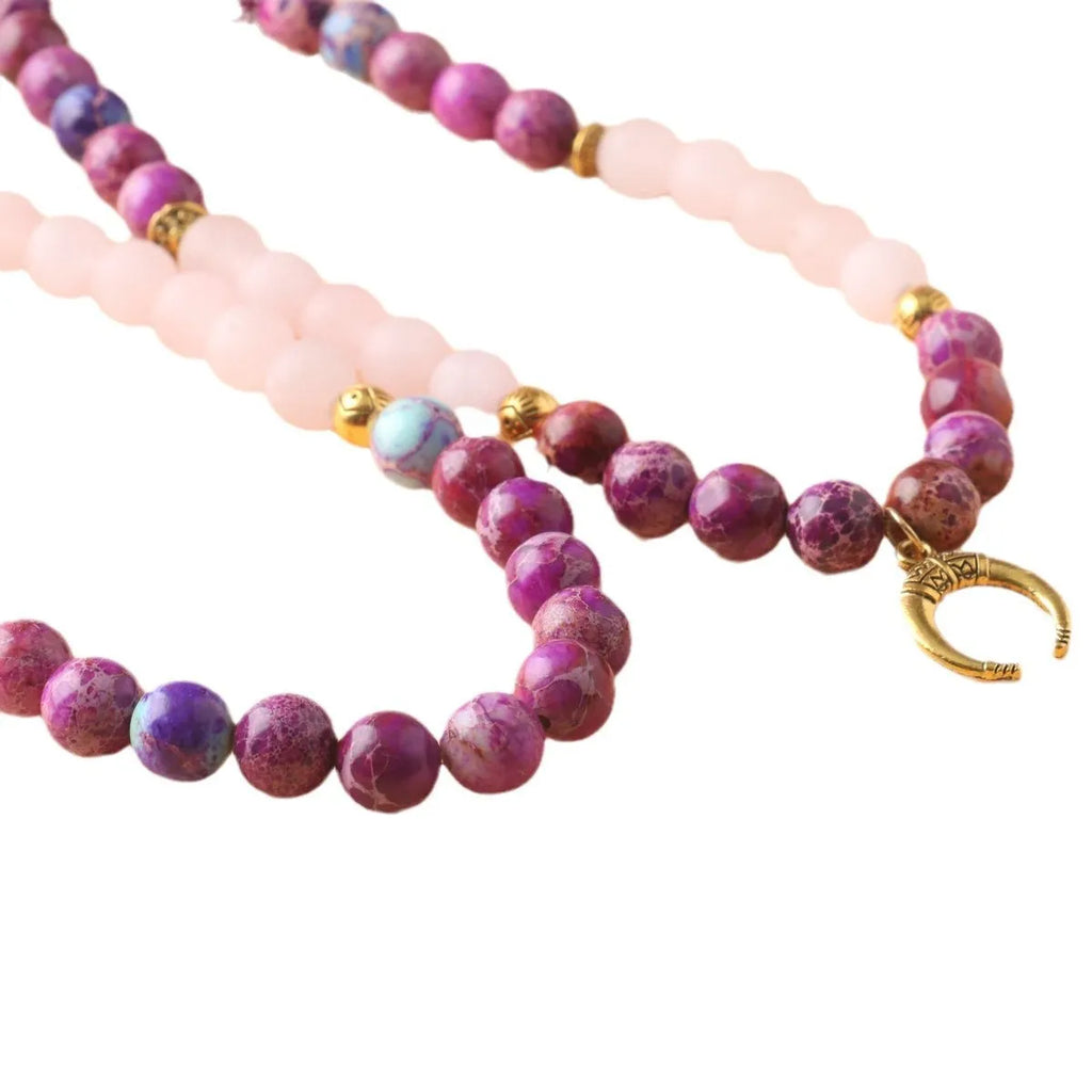 Close-up of a pink emperor stone crystal bead pendant on a necklace chain for casual wear.