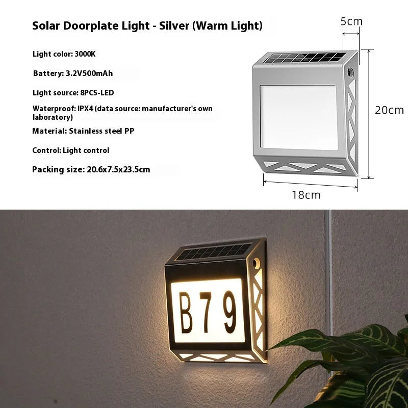 Black solar powered waterproof doorplate light with LED house numbers mounted on exterior wall