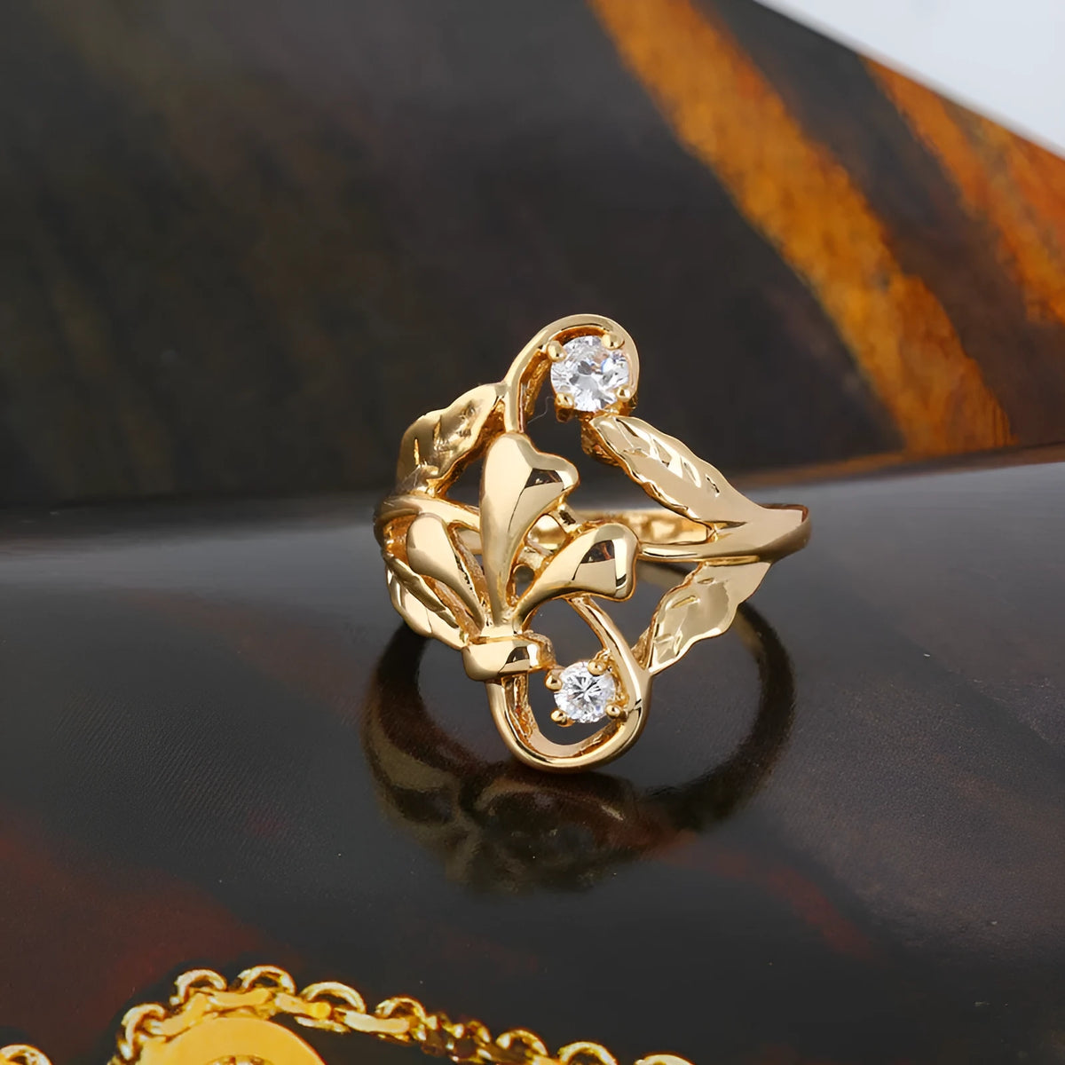 Gold tone copper ring with exaggerated irregular leaf design and white zircon stones, women's geometric band ring