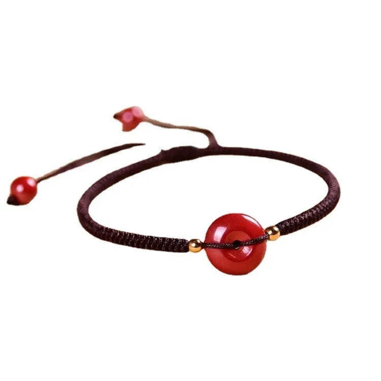 Cinnabar safety buckle bracelet with heart-shaped beads on adjustable rope cord in traditional birth year design