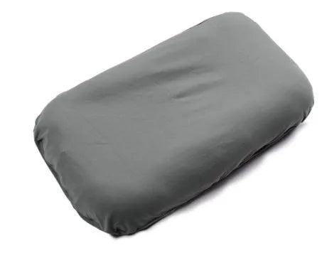 Beige portable cotton baby nest crib for newborns on a neutral background