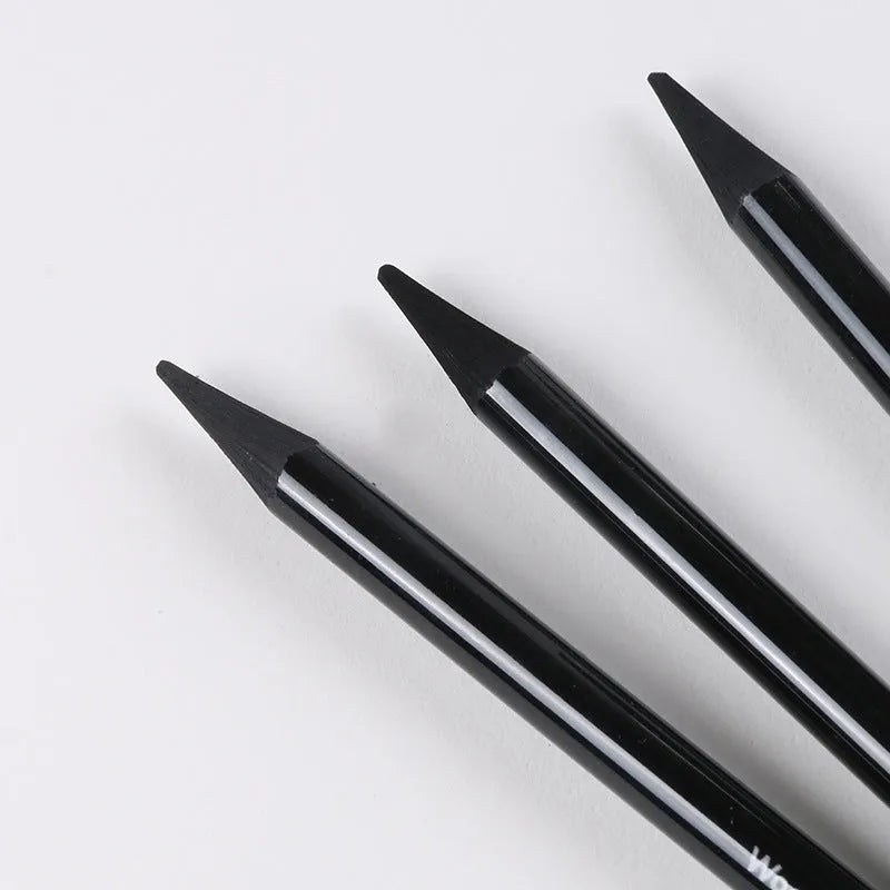 Set of six graphite and three carbonised drawing pencils with wooden shells on suction card packaging.