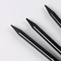 Set of six graphite and three carbonised drawing pencils with wooden shells on suction card packaging.