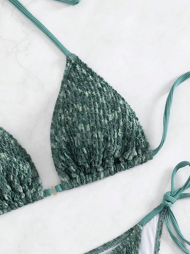 Women's green halter backless swimsuit with three-point design showing front and back styling