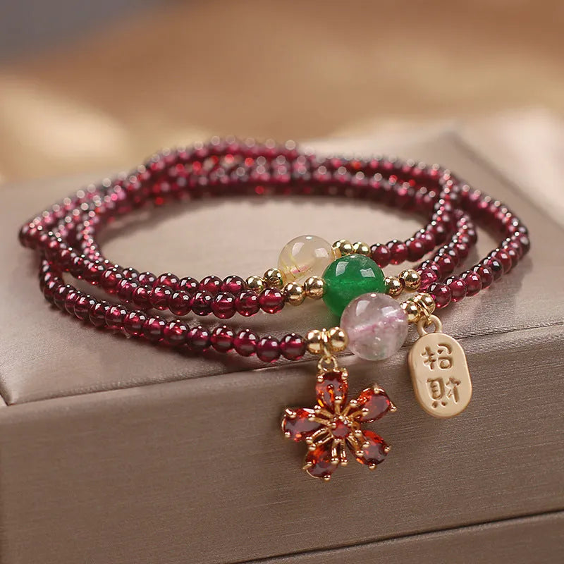 Natural crystal pomegranate red cherry blossom bracelet with sequins on wrist