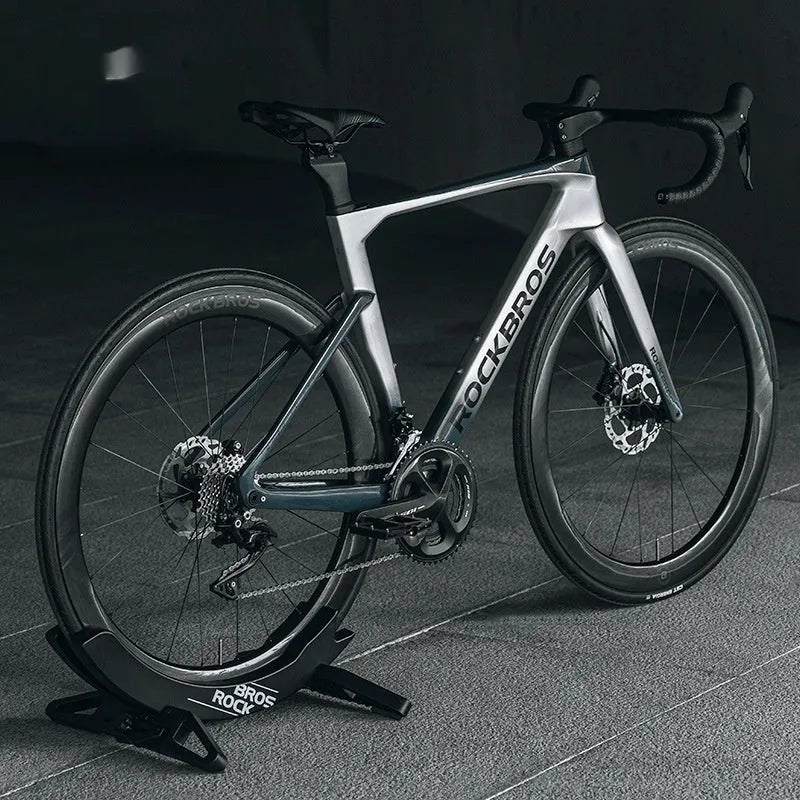 Black ABS plastic wall-mounted bicycle parking rack holder holding a mountain bike.