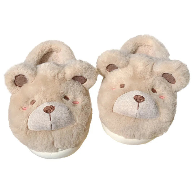 A pair of milky white baotou slippers with suede uppers and a cartoon pattern, showing the round toe shape.