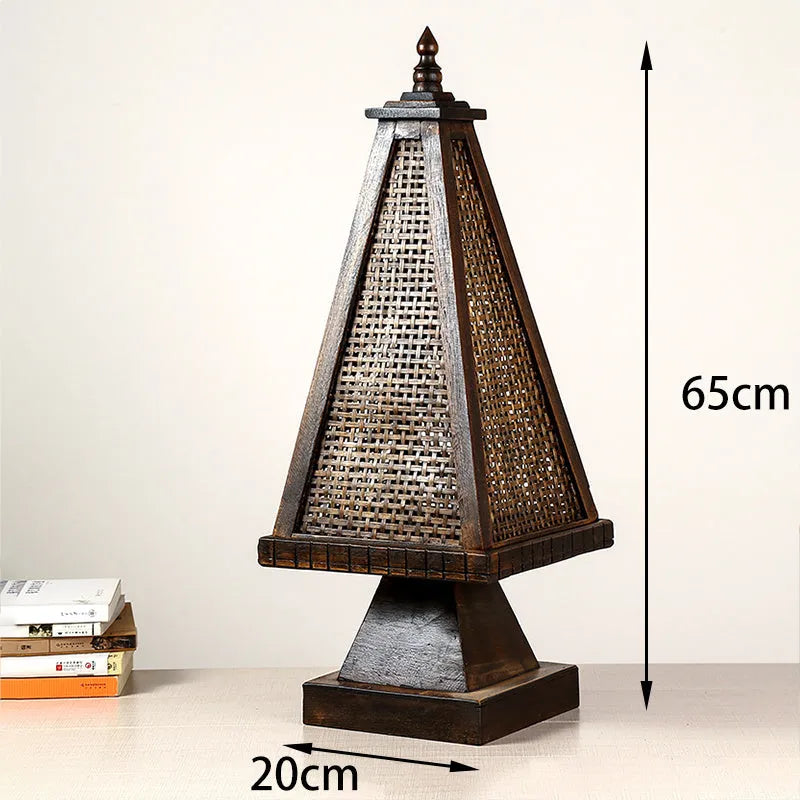 Retro wood table lamp with hand-woven straw rattan lampshade on a desk