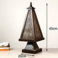 Retro wood table lamp with hand-woven straw rattan lampshade on a desk
