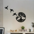 Black iron wall art wind chime hanging on a wall with a simple modern design