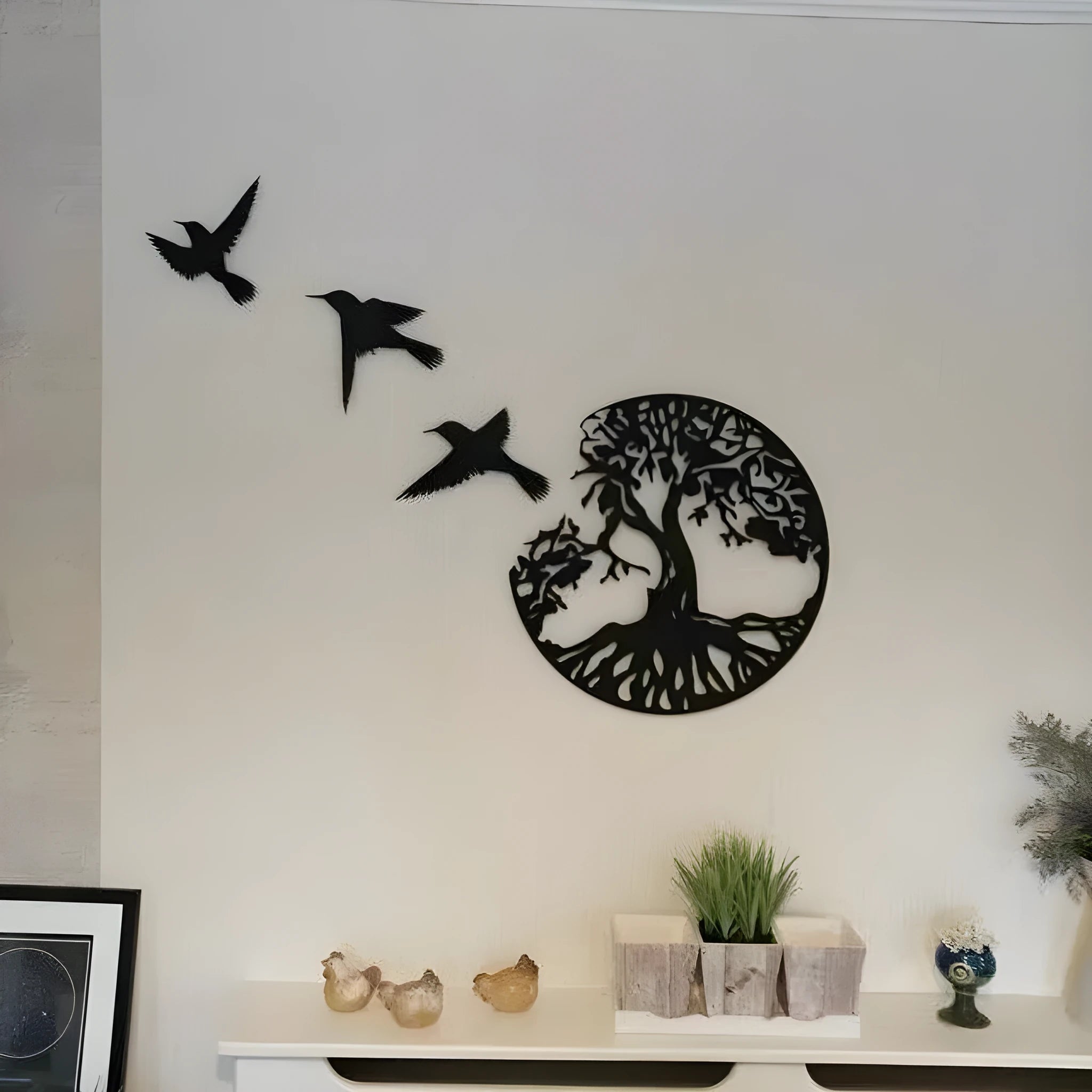 Black iron wall art wind chime hanging on a wall with a simple modern design