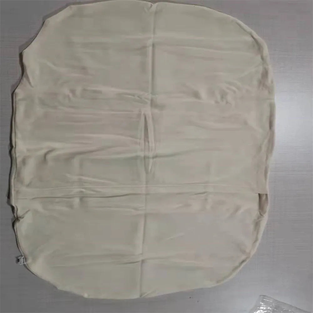 Beige portable cotton baby nest crib for newborns on a neutral background