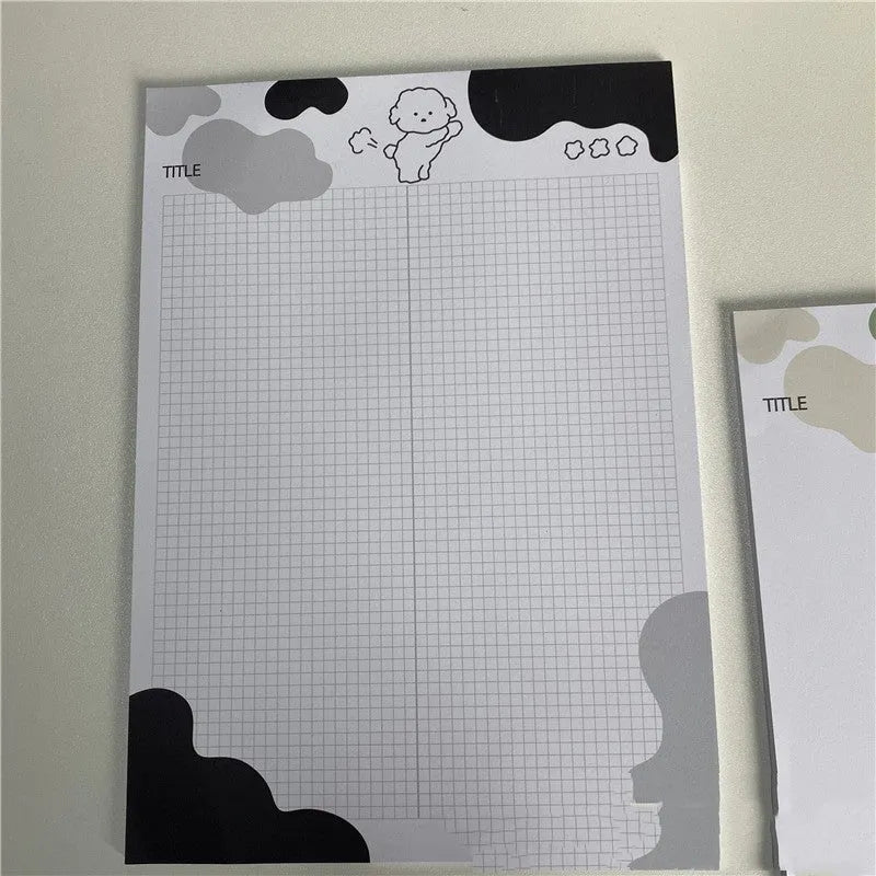 B5 sticky note pad with dog illustration cover, showing one sheet peeled back to reveal adhesive.