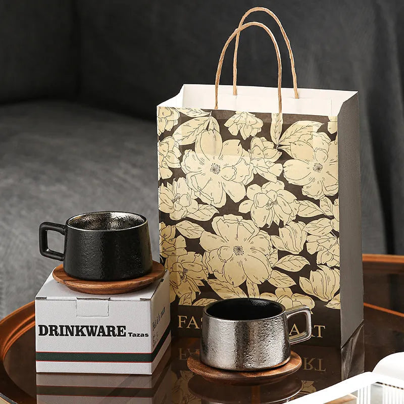 Gold-plated gift tumbler cup and box set on a desk