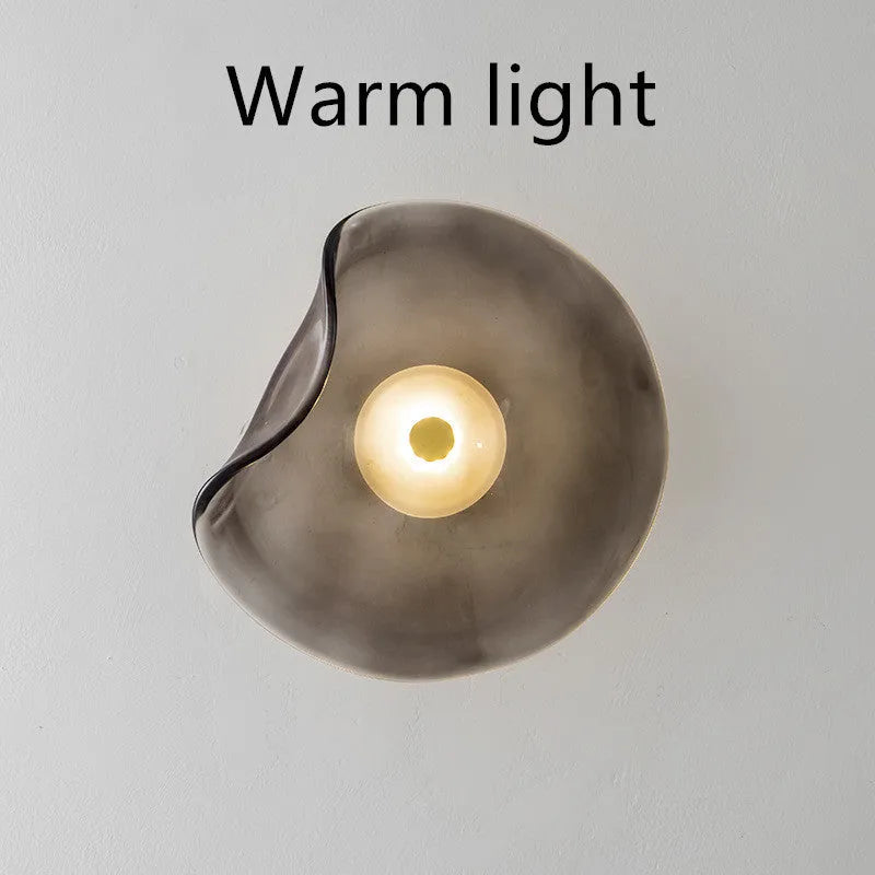 Round decorative wall lamp with glass shade in cognac colour for bedroom bedside lighting