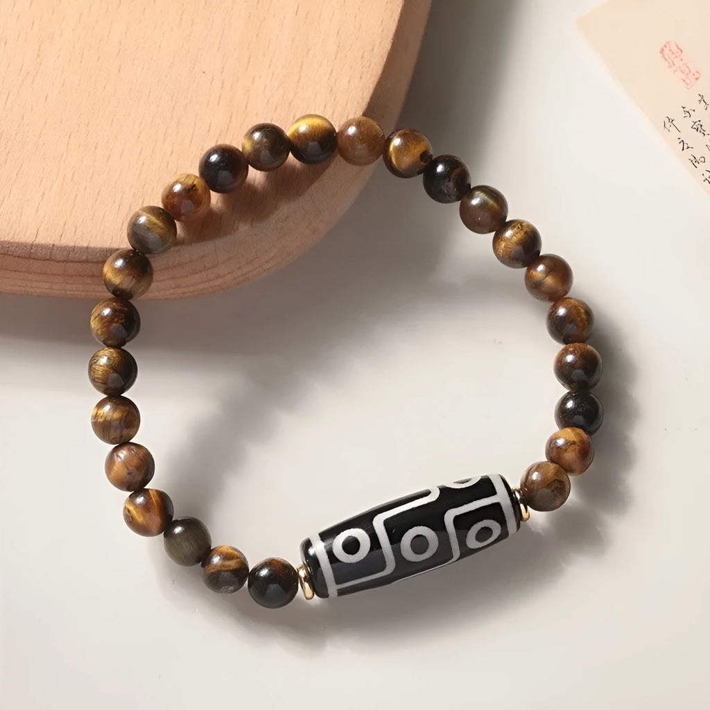 Ethnic style single circle bracelet with a patterned Tigereye Dzi bead on wrist.