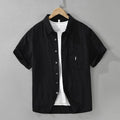 Women's loose-fitting lyocell cardigan-style top in black, shown on a model.