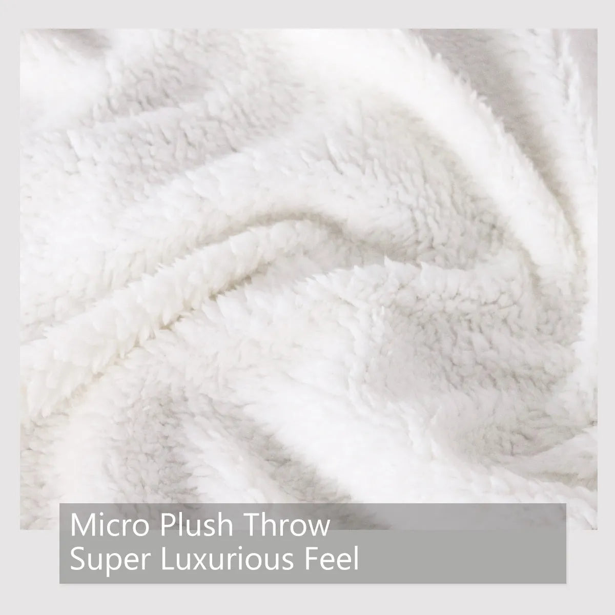 Multicoloured cat themed Sherpa fleece blanket 130x150cm with hemmed edges on a sofa