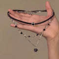 Women's leather heart necklace set showing double-layer and single-layer pendant designs on adjustable clavicle chain