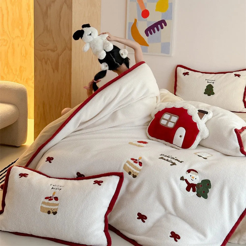 Winter Christmas cartoon patterned four-piece bedding set showing duvet cover, bed sheet, and pillowcases on a bed.