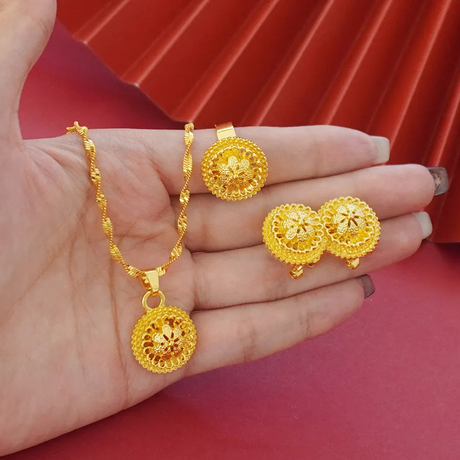 Gold-plated three-piece jewellery set with flower design, including necklace, earrings and ring