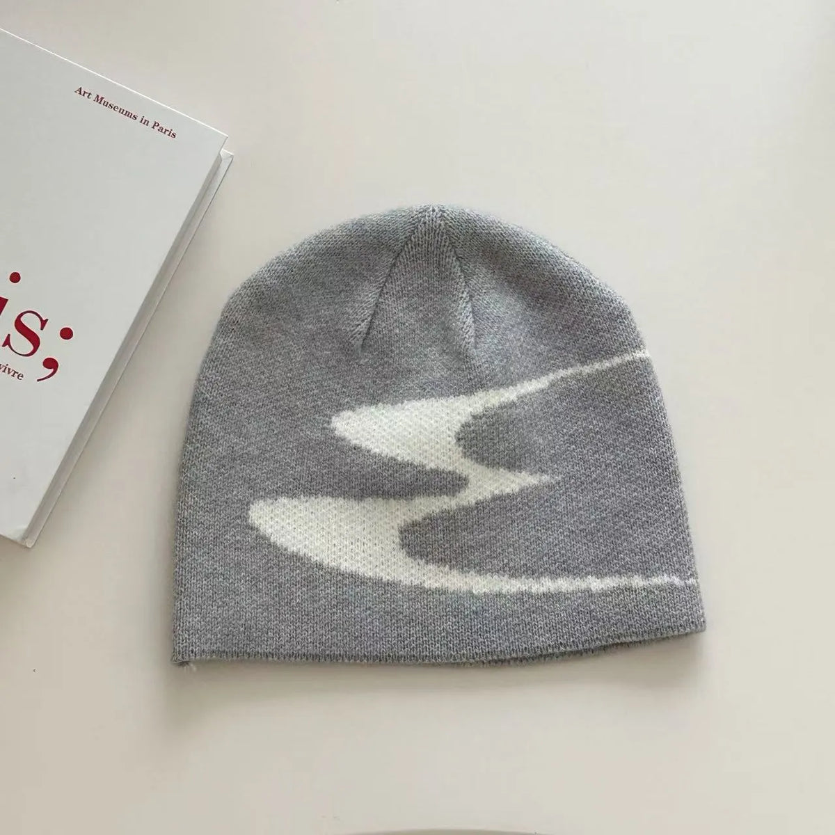 Acrylic thermal beanie hat in white colour showing woolen-style knitting texture