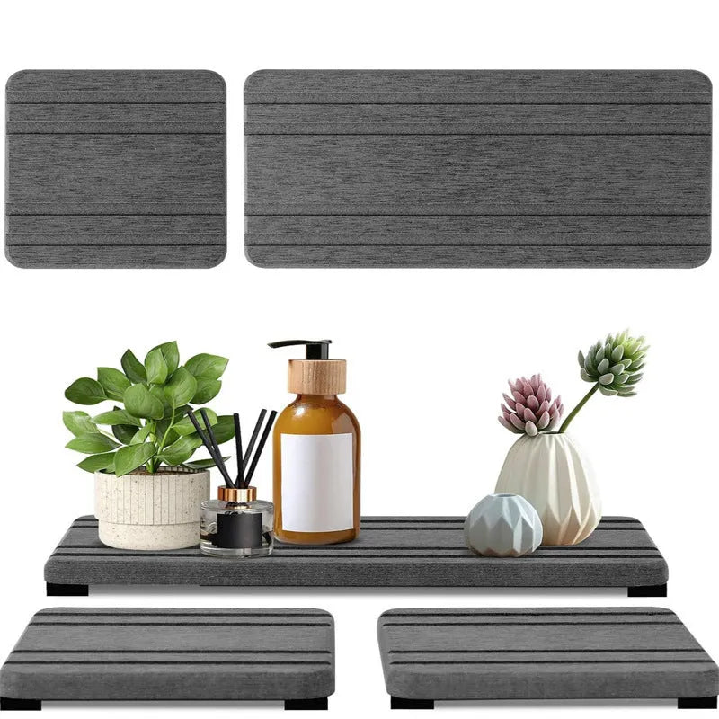 Set of three solid colour diatomite square drying mats for bathroom countertops.