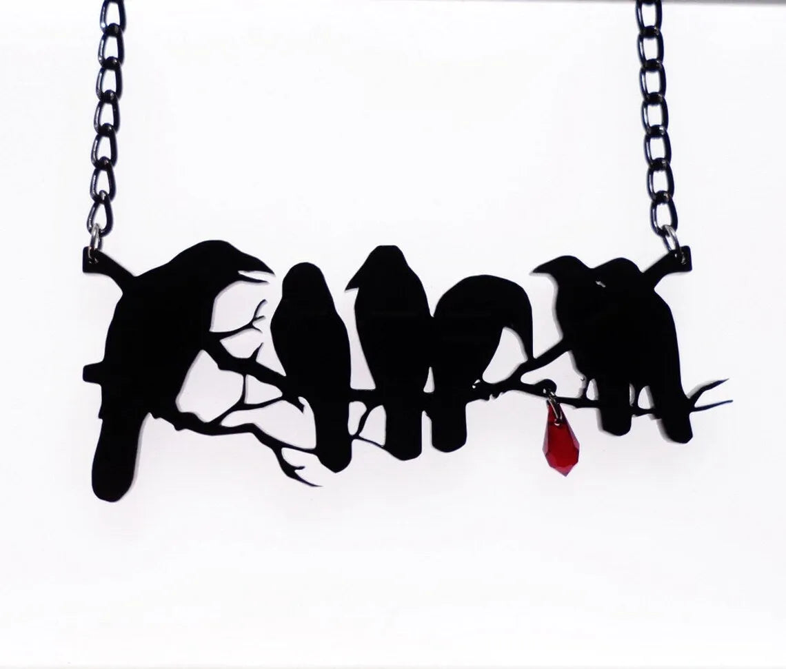 Black alloy crow pendant necklace with electroplated finish and cross chain, gothic bird jewellery.