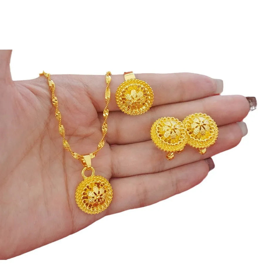 Gold-plated three-piece jewellery set with flower design, including necklace, earrings and ring