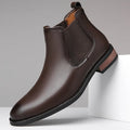 Men's black pointed-toe Chelsea boots with a high-top design and rubber sole on a white background.