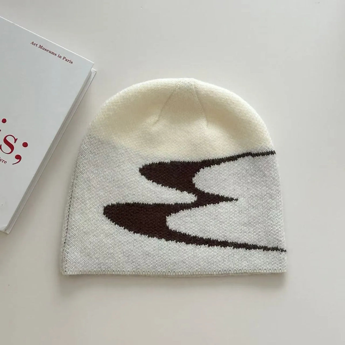 Acrylic thermal beanie hat in white colour showing woolen-style knitting texture