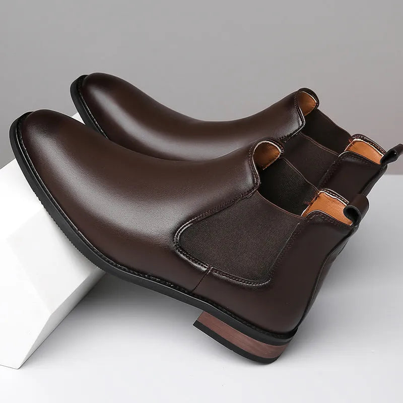 Men's black pointed-toe Chelsea boots with a high-top design and rubber sole on a white background.
