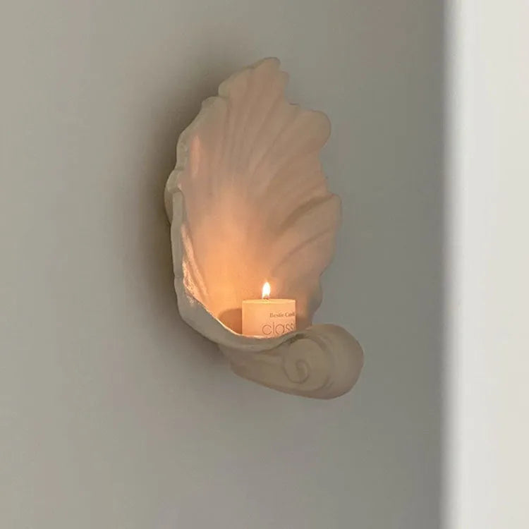 White resin fruit plate ornament with detailed simulation shell design on a table.