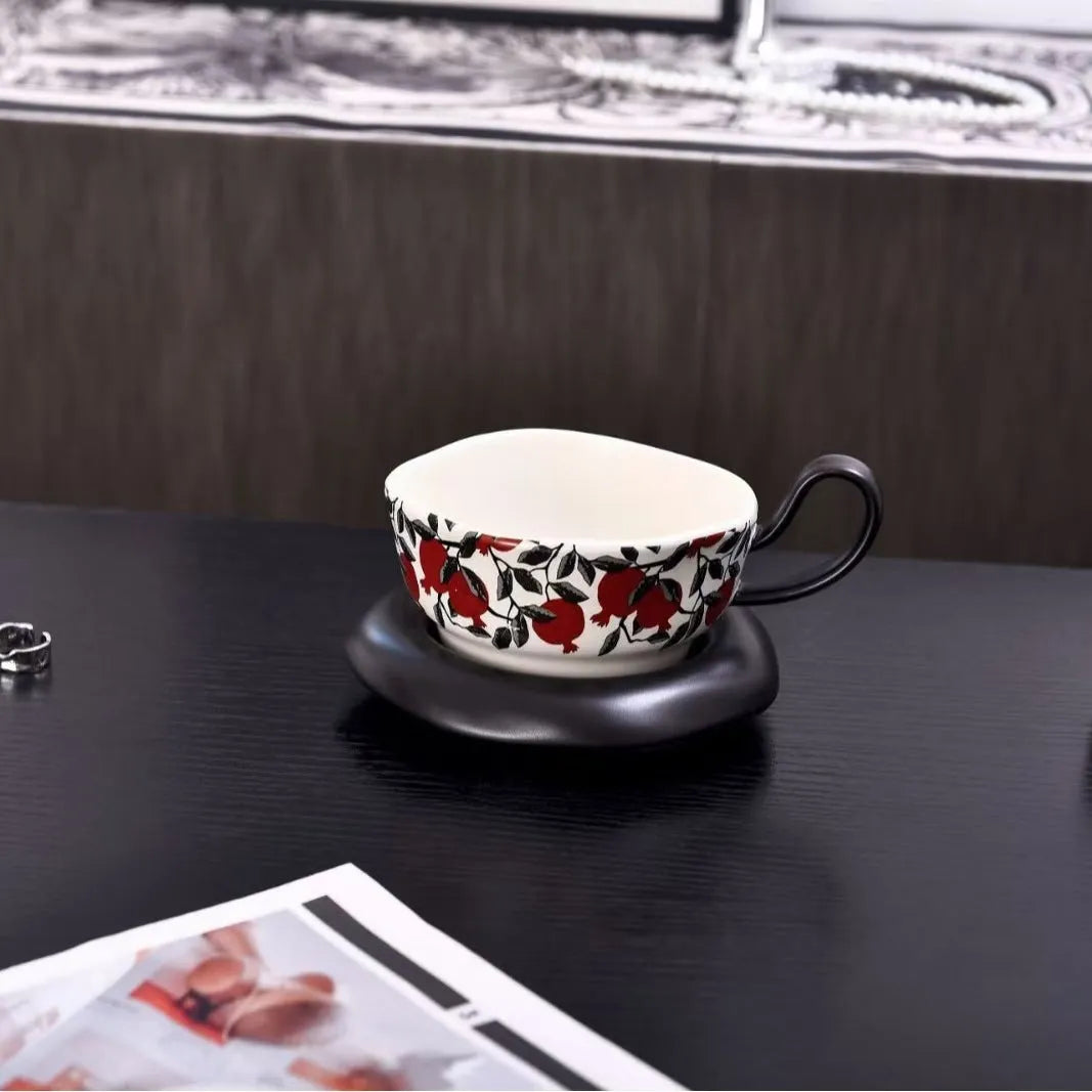 Antique style ceramic coffee cup and saucer set in black pomegranate or orange citrus retro design.