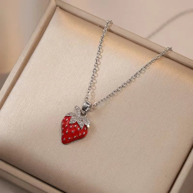 Titanium steel necklace with O-ring chain and a delicate cherry pendant in a gold-tone finish.