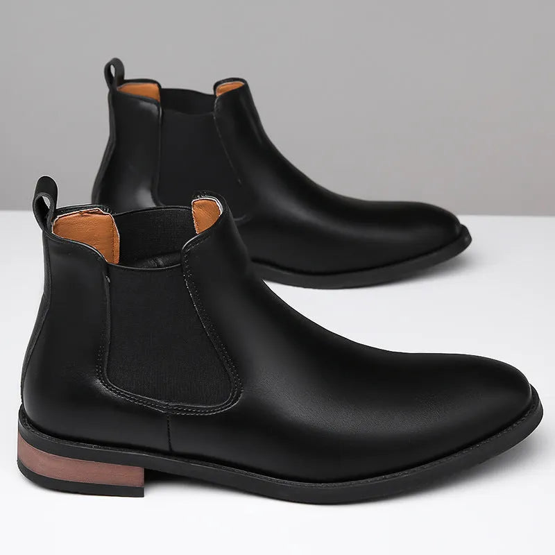 Men's black pointed-toe Chelsea boots with a high-top design and rubber sole on a white background.