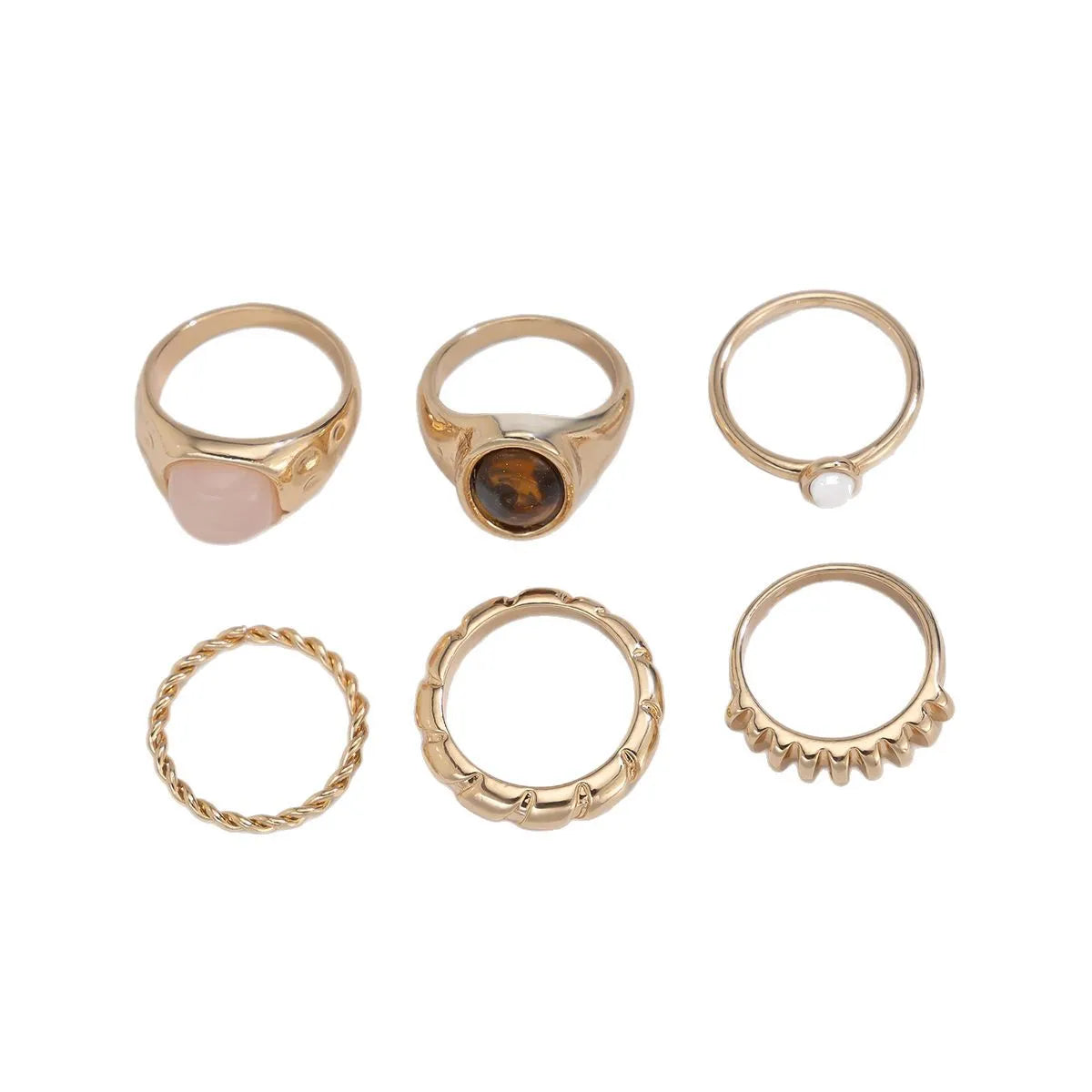 Set of six light gold geometric and round alloy stacking rings arranged together