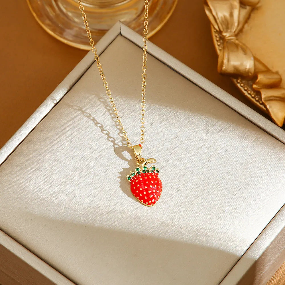 Titanium steel necklace with O-ring chain and a delicate cherry pendant in a gold-tone finish.