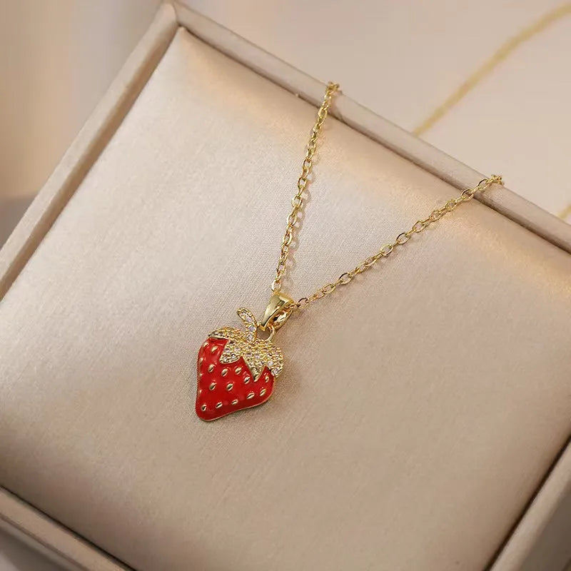 Titanium steel necklace with O-ring chain and a delicate cherry pendant in a gold-tone finish.