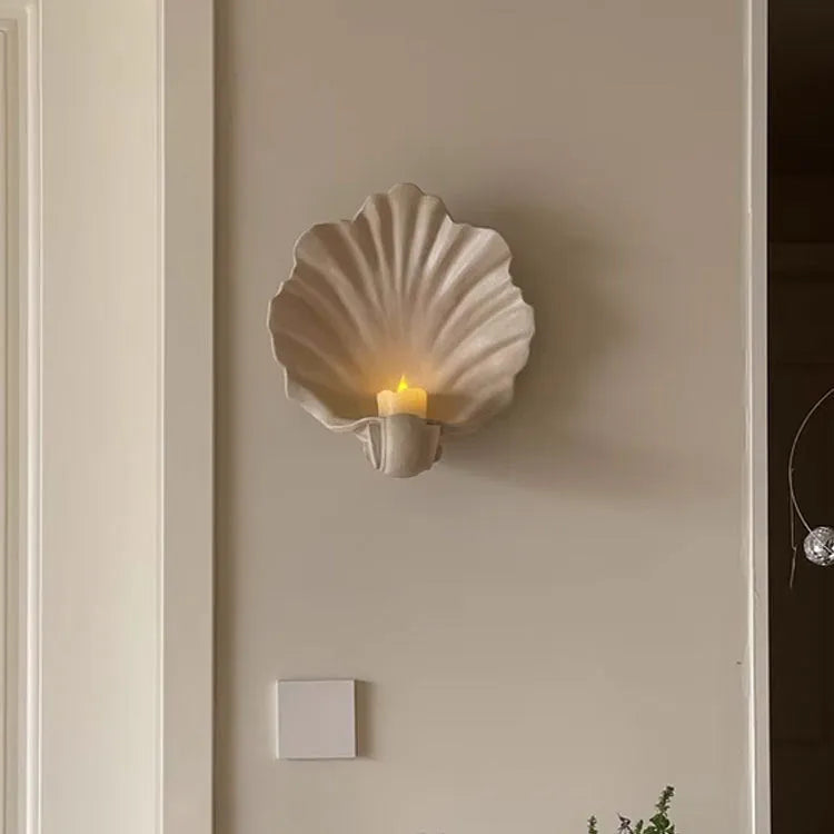 White resin fruit plate ornament with detailed simulation shell design on a table.