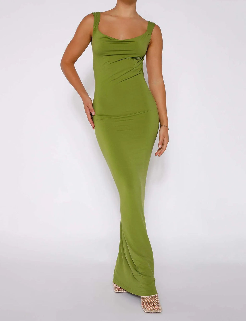 Backless sling style dress with spaghetti straps in milk silk fabric, shown in champagne colour with slim fit silhouette